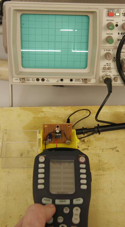 Remote control aimed at a detector wired to an oscilloscope